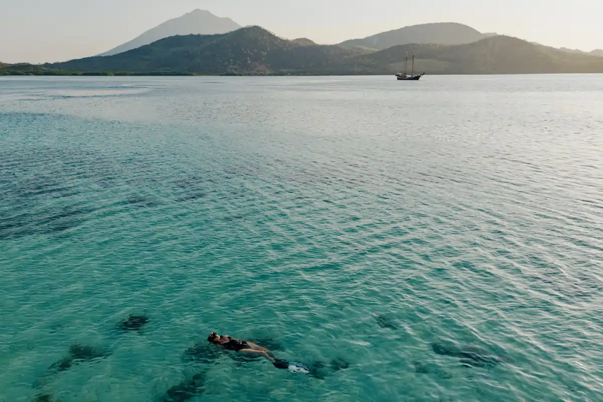 Female guest snorkeling in a beautiful bay